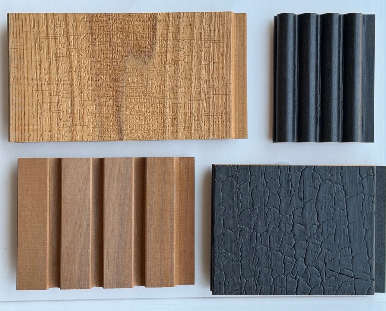 Four timber finish samples — textured oak, black fluted, grooved slat and charred crackle panels