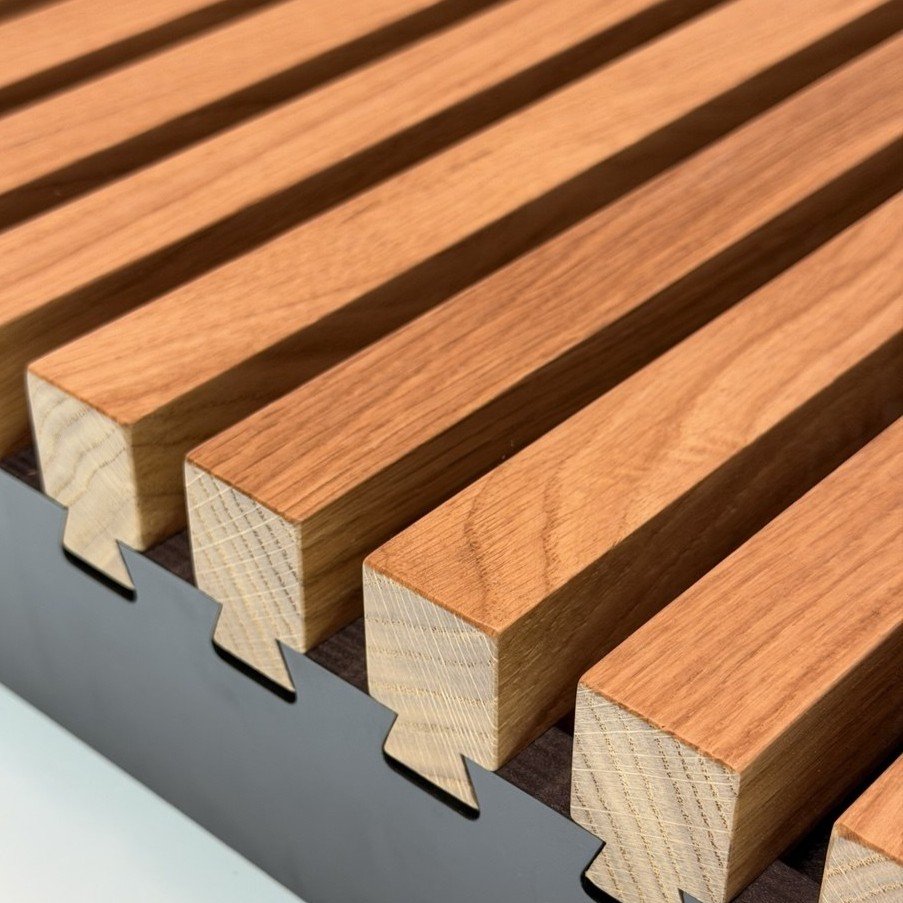 Solid oak slat battens with dovetail-cut feet on a dark base