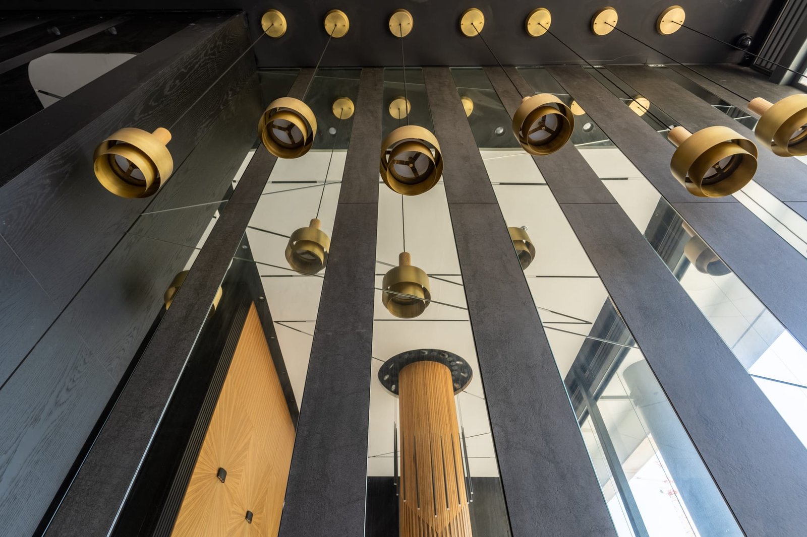 Stone soffit with rows of brass cylinder pendants