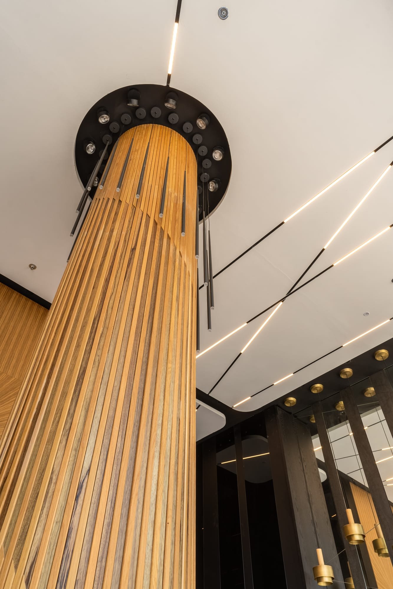 Cascading wood-slat cylindrical ceiling feature